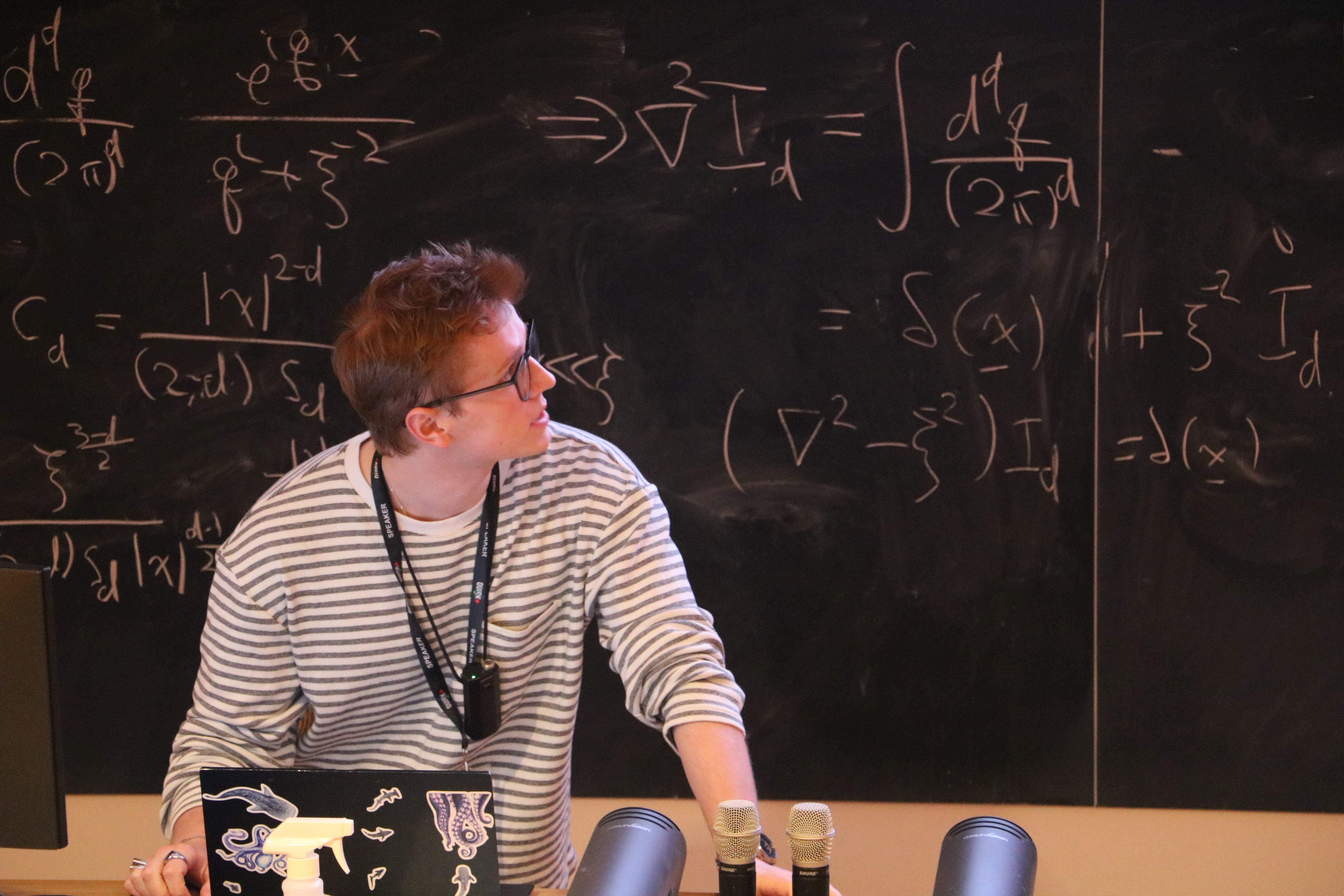 A speaker explaining equations